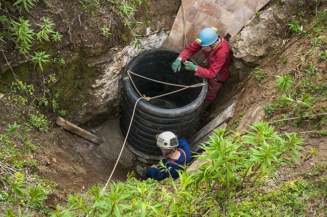 Roy Rodgers and John Sharp fitting a new section of entrance pipe. Photo: Phil Wolstenholme.